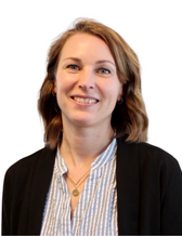 Portrait photo of researcher Kristin Blom smiling at the camera.